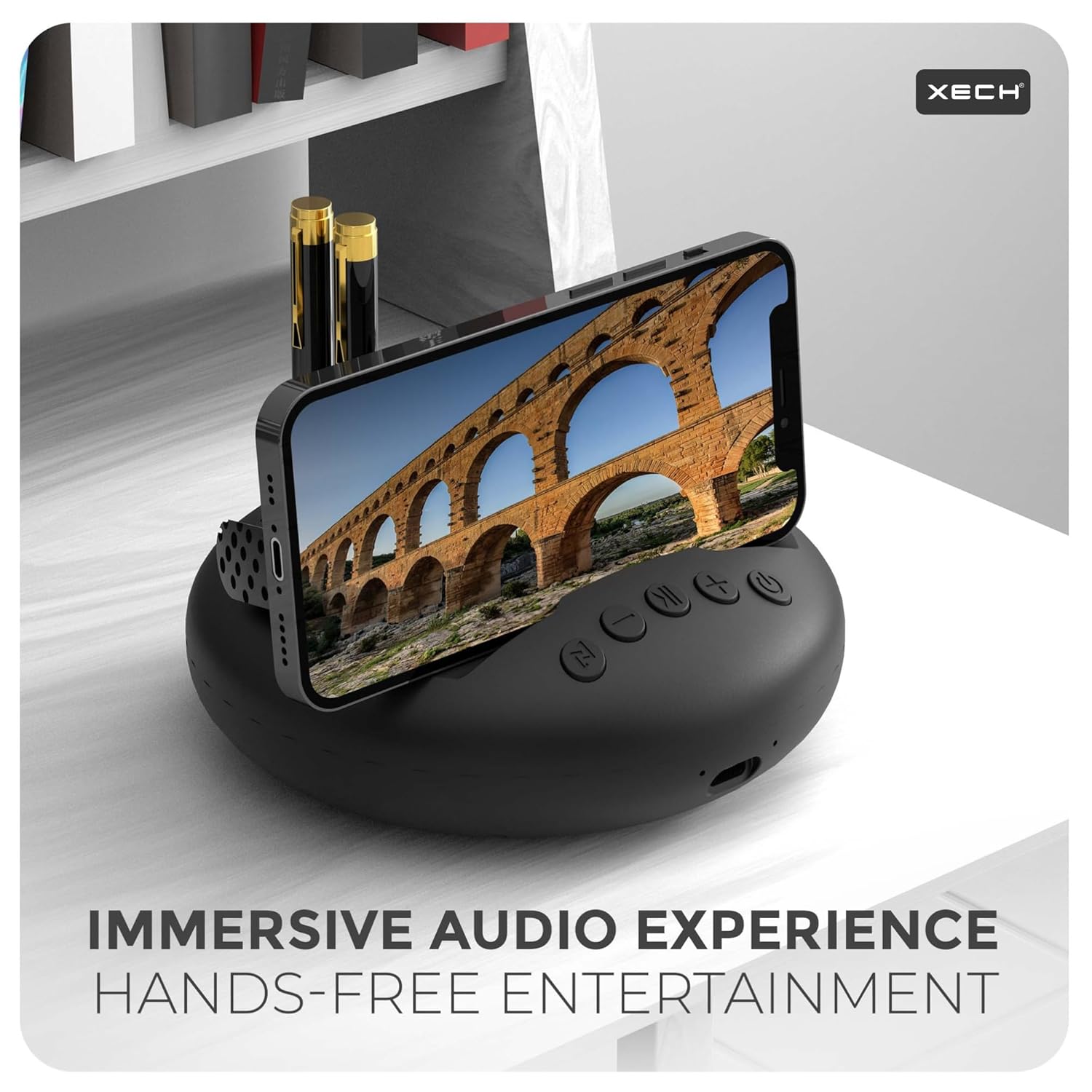 Xech Wireless Mini Speaker showcasing a smartphone holder for hands-free entertainment and immersive audio experience.
