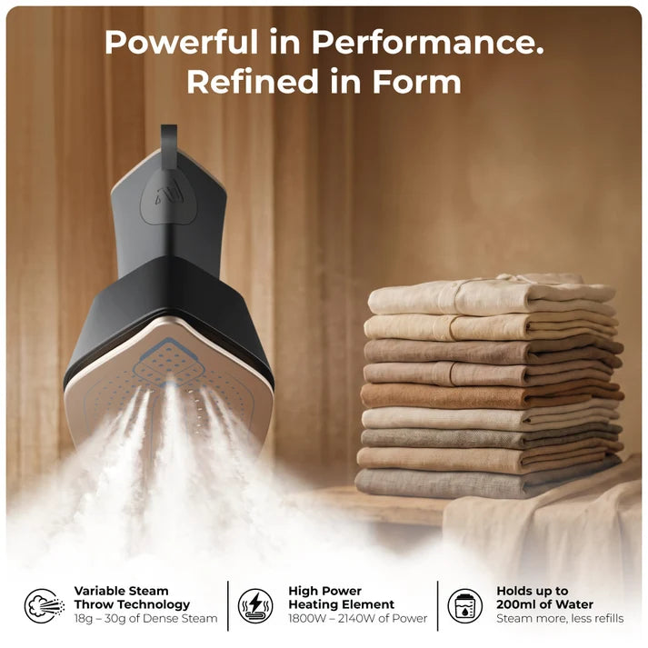 XECH Imperia Garment Steamer releasing steam, with stacked clothes in the background, showcasing its powerful performance.